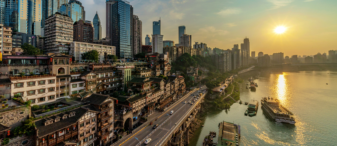 Chongqing developed city with a beautiful sunset, cars on a highway and ships