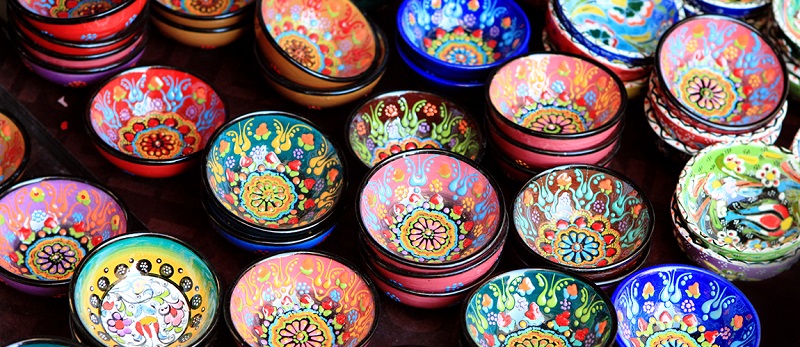 Bright painted bowls on the table, manufacturing
