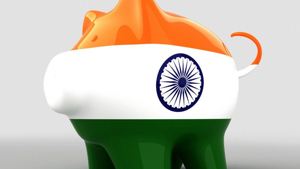 Piggy bank with digital currency painted in the Indian flag colors