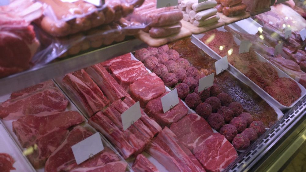 Meat and meat products displayed on shelves in a supermarket from China and Philippines.