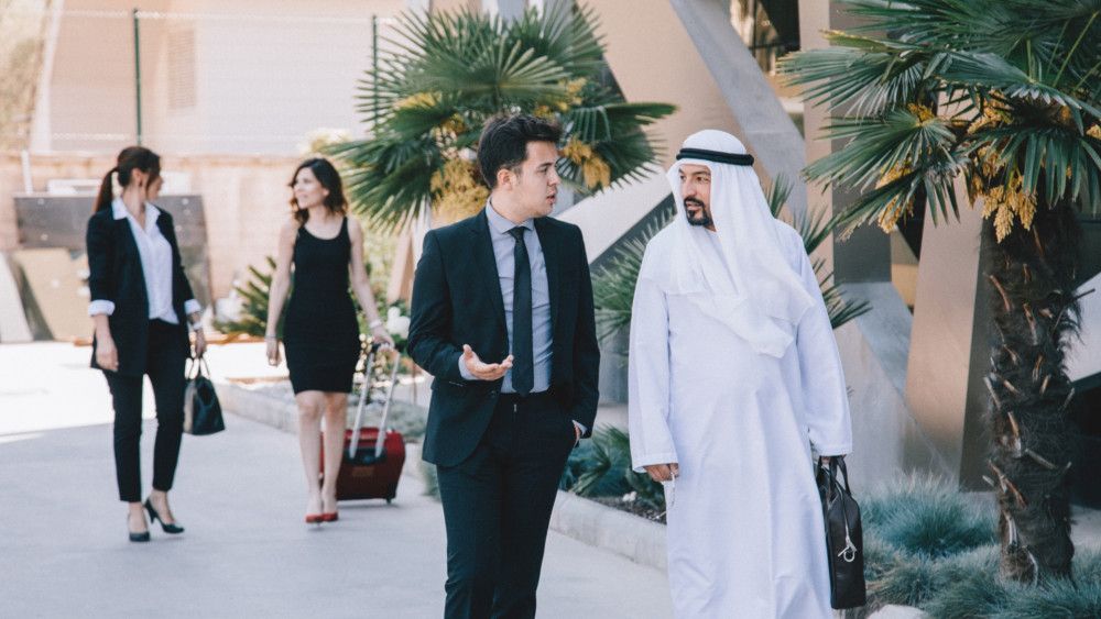 Two businessmen (from Israel and UAE) walking and talking about agriculture, biotechnology and economic cooperation.
